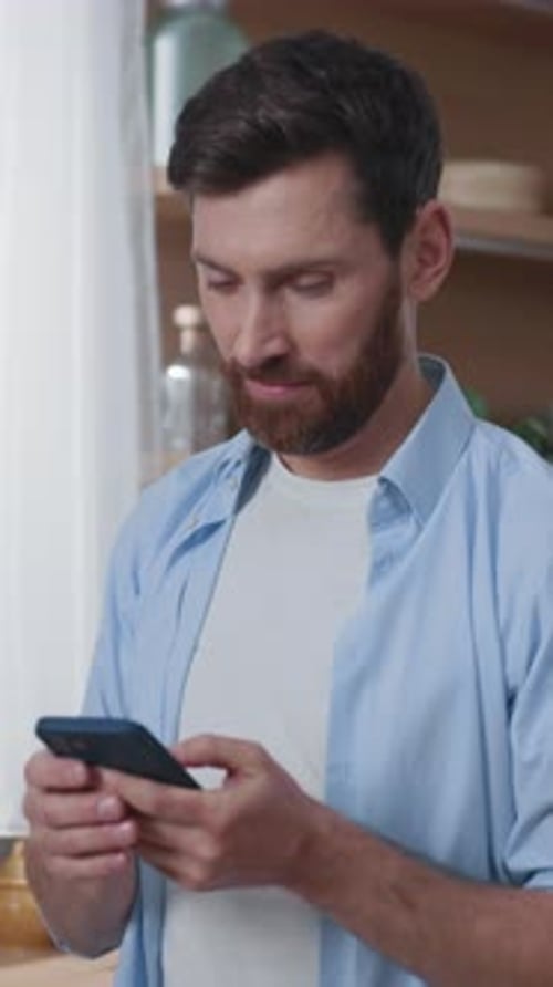 A Man is Engaged with a Smartphone in a Contemporary Setting Highlighting Modern Technology