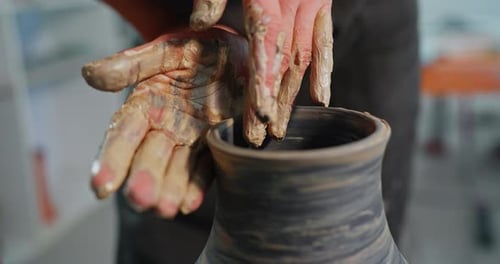 Potter Shaping Clay on Wheel Creates Vase