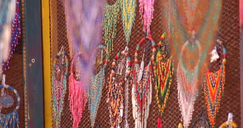 Colorful dream catchers hanging on wire mesh fence