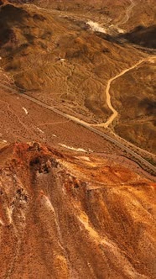 Flight above the lifeless arid landscape of Mojave desert