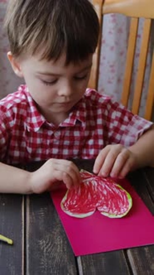 Vertical Video Child Attach DIY Heart to Mother Day Card Using Plasticine