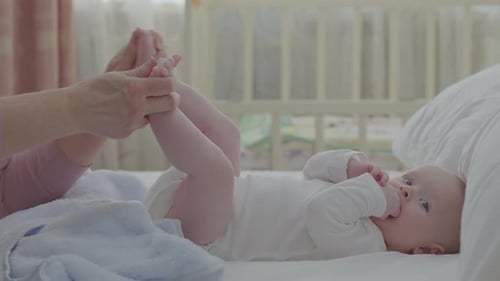 Baby Lying Down Getting Foot Massage Indoors
