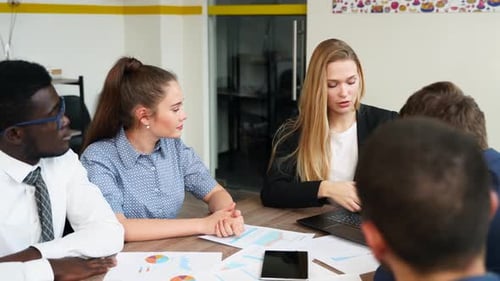 Business Team Meeting Data Analysis in Modern Office