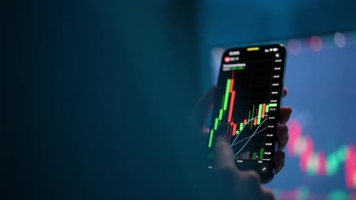 Tracking Shot of Female Stock Trader Checking Stock Market Data Using Mobile Phone Scrolling