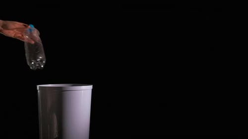 Throwing Plastic Bottle into White Trash Can