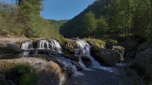 Flying Into The Waterfalls In The Forest In The Summer With Beautiful Nature Around Shot On A Drone