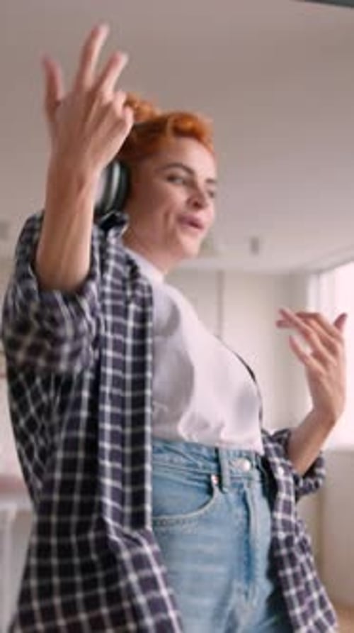 Woman with Headphones Dances and Sings at Home