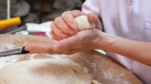 Capable and Skilled Hands Meticulously Preparing Dough for the Art of Baking Delicious Treats