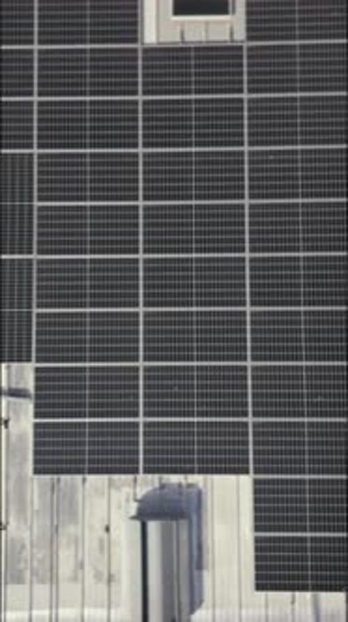 Drone, architecture and people on rooftop, solar panels or property development with sustainability