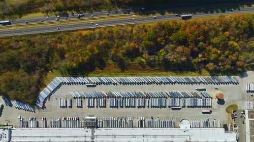 Aerial View of Large Commercial Loading Bay with Many Delivery Trucks Unloading and Uploading Retail