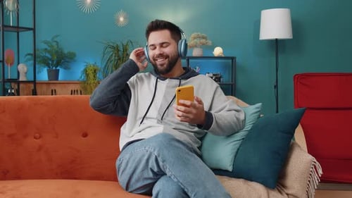 Man Listening to Music on Headphones at Home