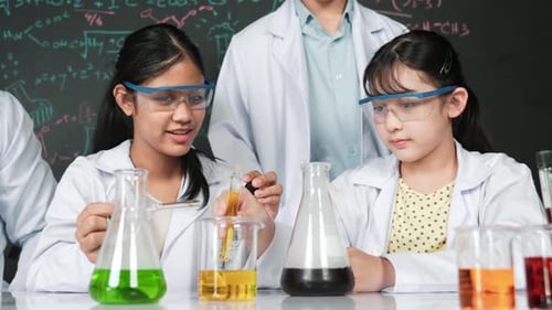 Kids in Science Class Experimenting with Liquids