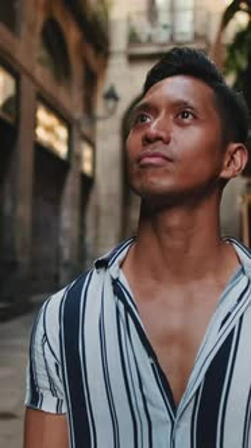 Young man tourist walks along the narrow street of the old city