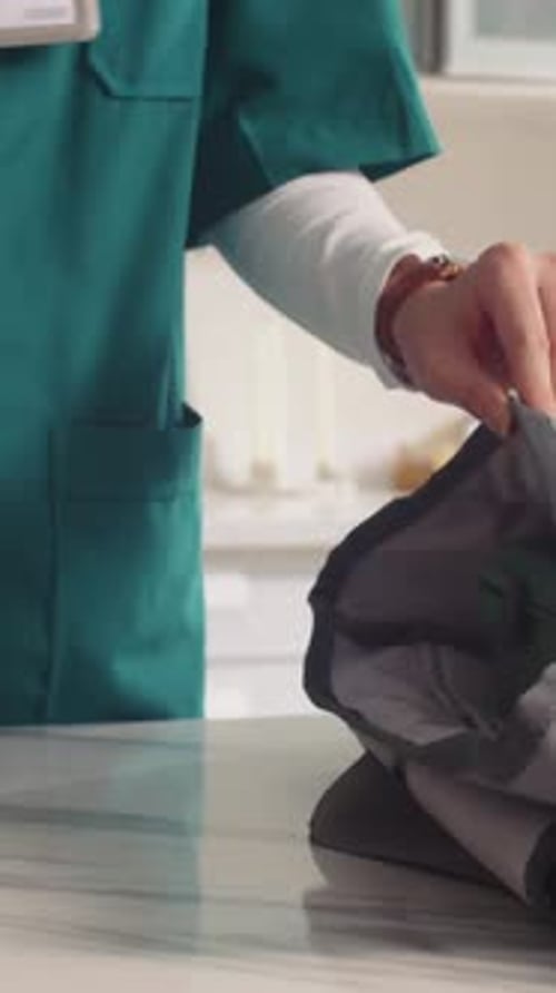 Vertical of Medical Worker Putting Lunch Box in Bag