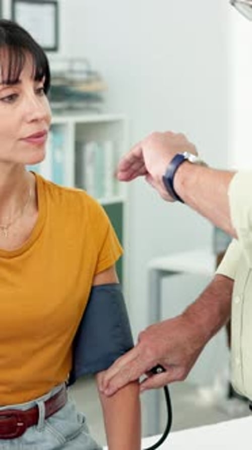 Doctor Taking Blood Pressure of a Woman Patient