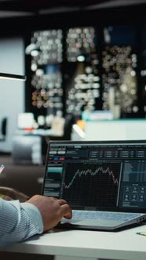 Vertical Video African American Consultant Examining Data on Stock and Forex Trading