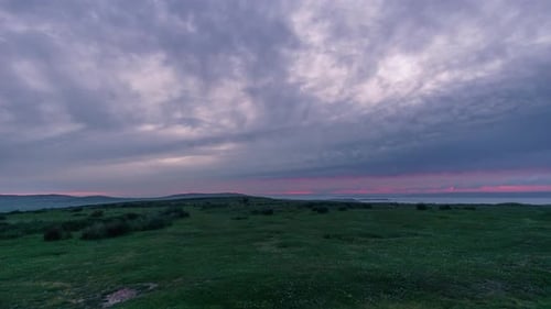Moving rain clouds at evening twilight after sunset over Gower, Wales, United Kingdom