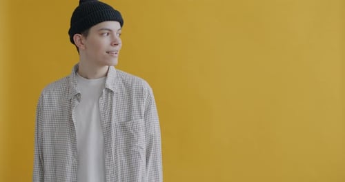 Smiling Young Adult Posing Against Yellow Background