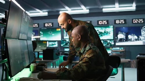 Two Men Working With Computers and Screens