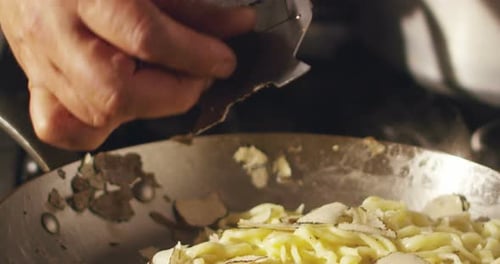 Chef Adds Truffle to Steaming Pasta Dish