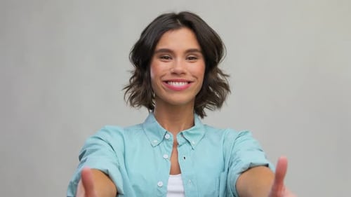 Smiling Woman Giving Thumbs Up Gesture of Approval