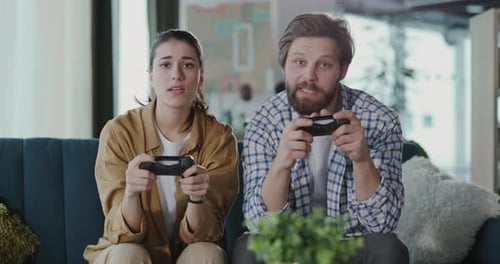 Young Couple Playing Video Games at Home