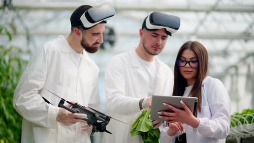 Scientists Analyzing Data in a Modern Greenhouse