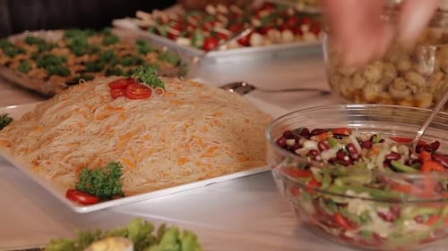 a young girl chooses a different buffet food with many different salads