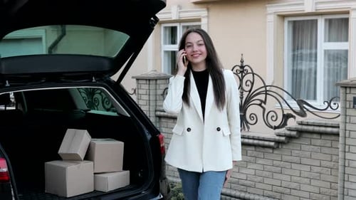 Woman by Car Talking on the Phone