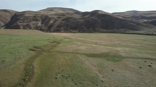 Expansive Aerial View of Rolling Hills and Grassland