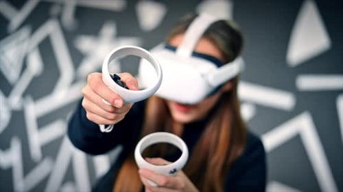 Woman Using Virtual Reality Headset and Controllers
