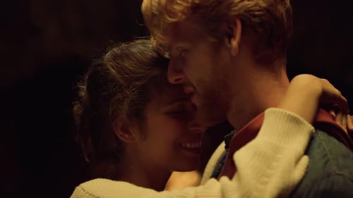 Romantic Young Couple Embracing Affectionately in Dark Setting