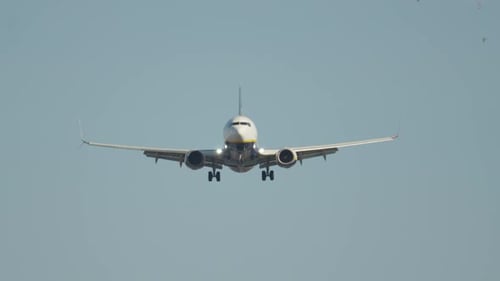 Airplane landing approach to runway amidst clear skies