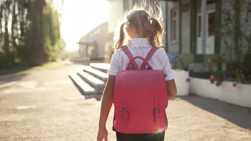Girl with a Backpack Goes to School