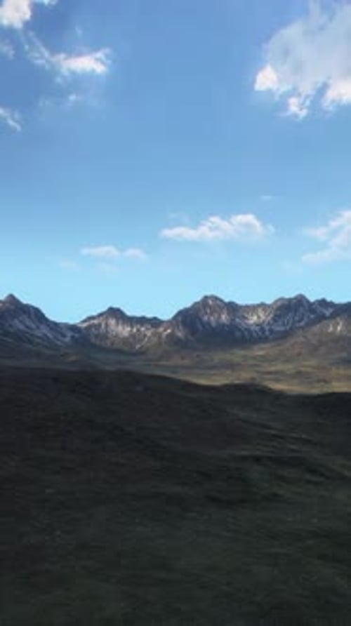 A Majestic Mountain Range with Scattered Clouds in the Sky