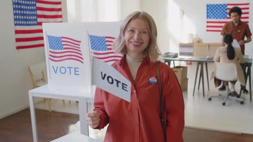 Portrait of Happy Mature Woman with Voter Badge at Polling Place