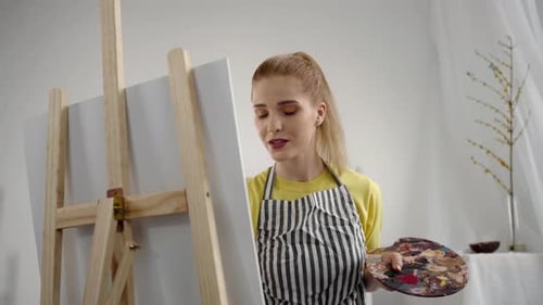 Talented Young Woman Drawing Picture on Canvas in Artist Studio Portrait Happy and Inspired Girl in