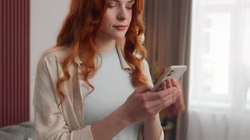 Woman Using Mobile Phone Inside Airy Home