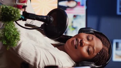 Vertical Video Journalist Records Interview with Cellphone on Tripod Stabilizer in Studio Reviewing