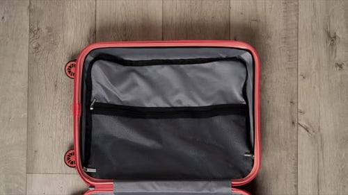 Stop Motion Animation Packing Suitcase With Colorful Clothes and Travel Accessories of Top View