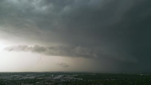 Storm Clouds Over City With Rain Falling