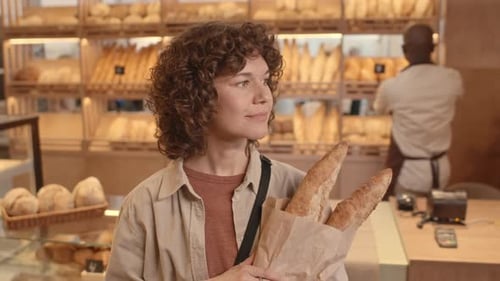 Portrait of Young Woman with Fresh Bread at Bakery