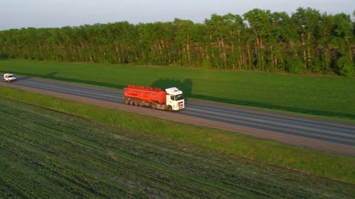 A Tanker Truck is Driving Along the Highway Aerial View