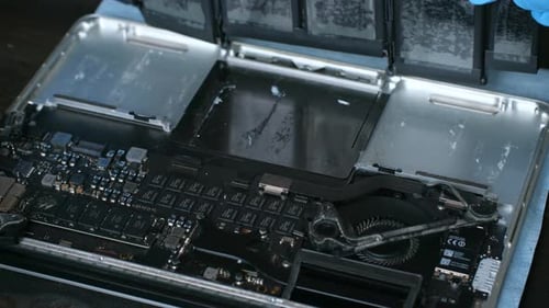 Hands Replace Battery in Laptop Computer