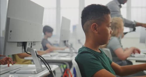 Grundschüler arbeiten an kreativen Projekten am Computer Diverse Kinder praktizieren digital
