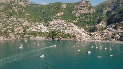 Aerial: Slow panning drone shot of Positano in Amalfi coast, Italy during a sunny day