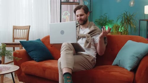 Man on Laptop Video Call at Home