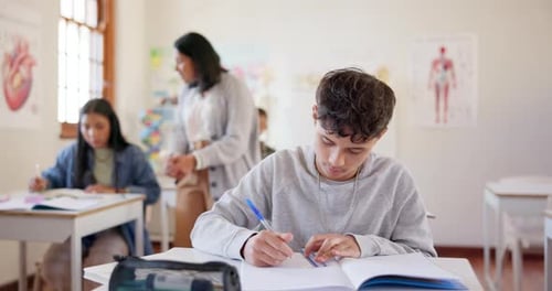 High school, classroom students and boy notebook writing, learning education and copy knowledge