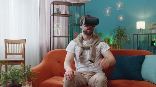 Man Experiencing Virtual Reality on Comfortable Couch