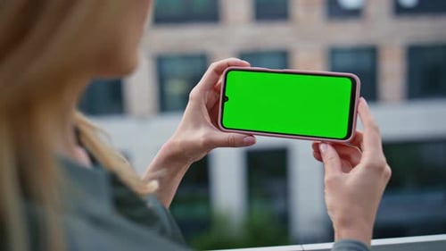 Hands Holding Horizontal Chromakey Mobile Phone at City Closeup Woman Online